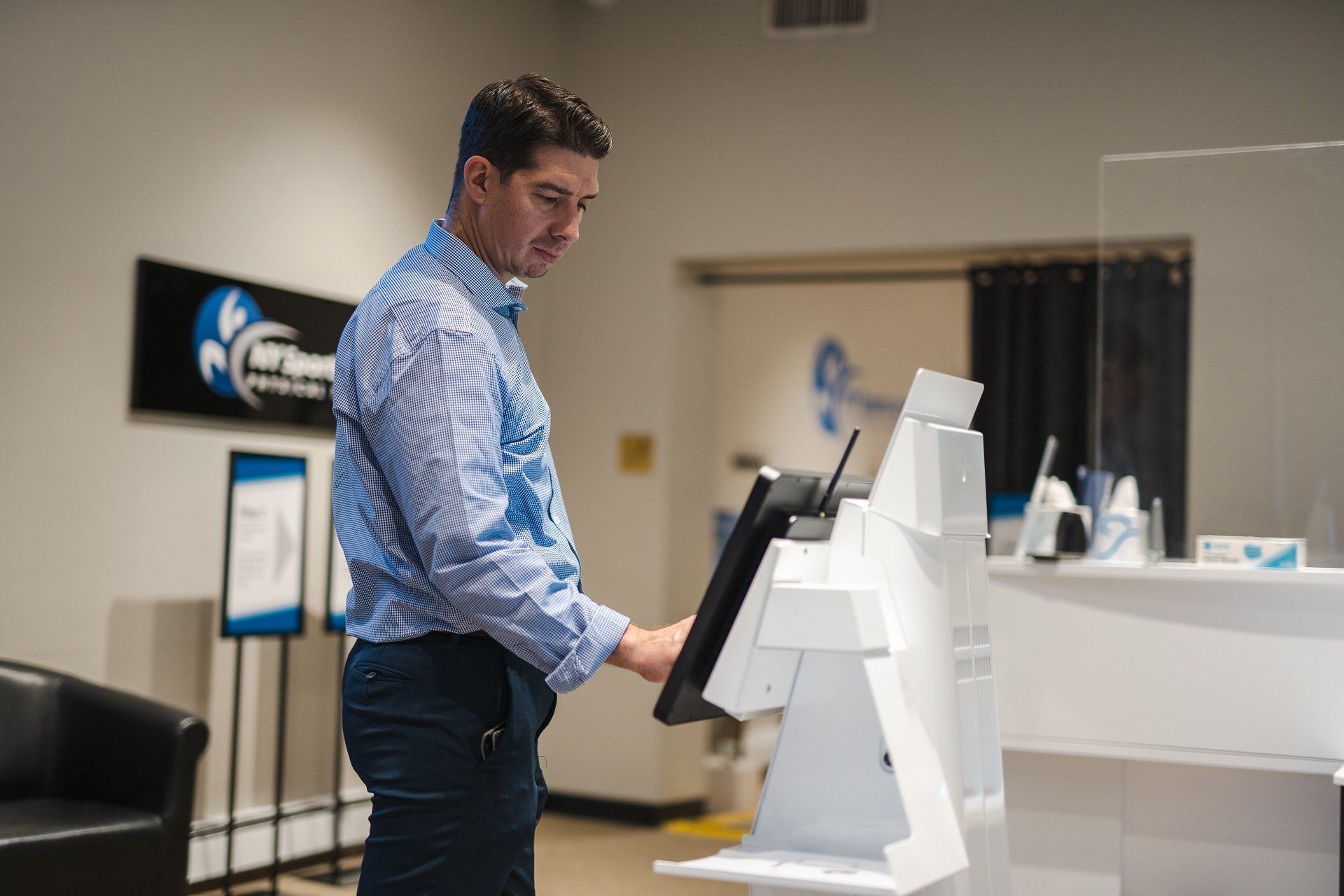 man-using-the-kiosk-in-one-of-the-types-of-outpatient-clinics Man using the kiosk in one of the types of outpatient clinics
