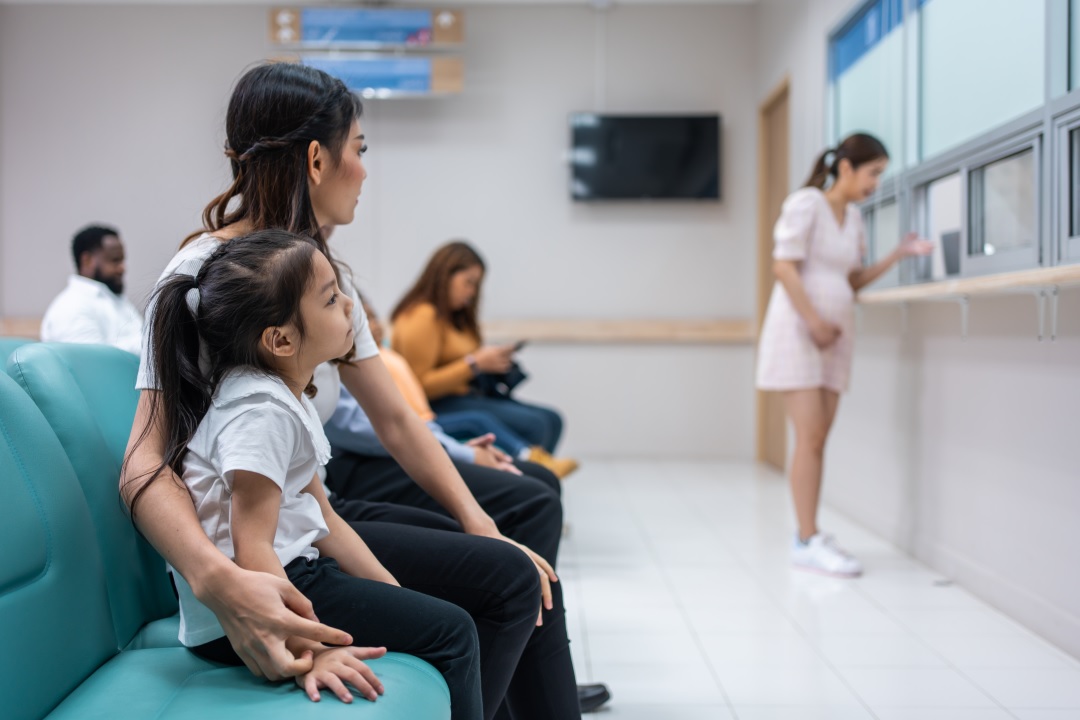 parent-child-waiting-in-clinic-how-to-improve-patient-wait-times Parent and child waiting in clinic, how to improve patient wait times