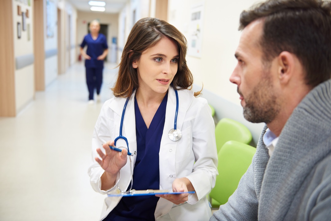 Doctor talking to her patient Doctor implementing patient experience trends to communicate with patient
