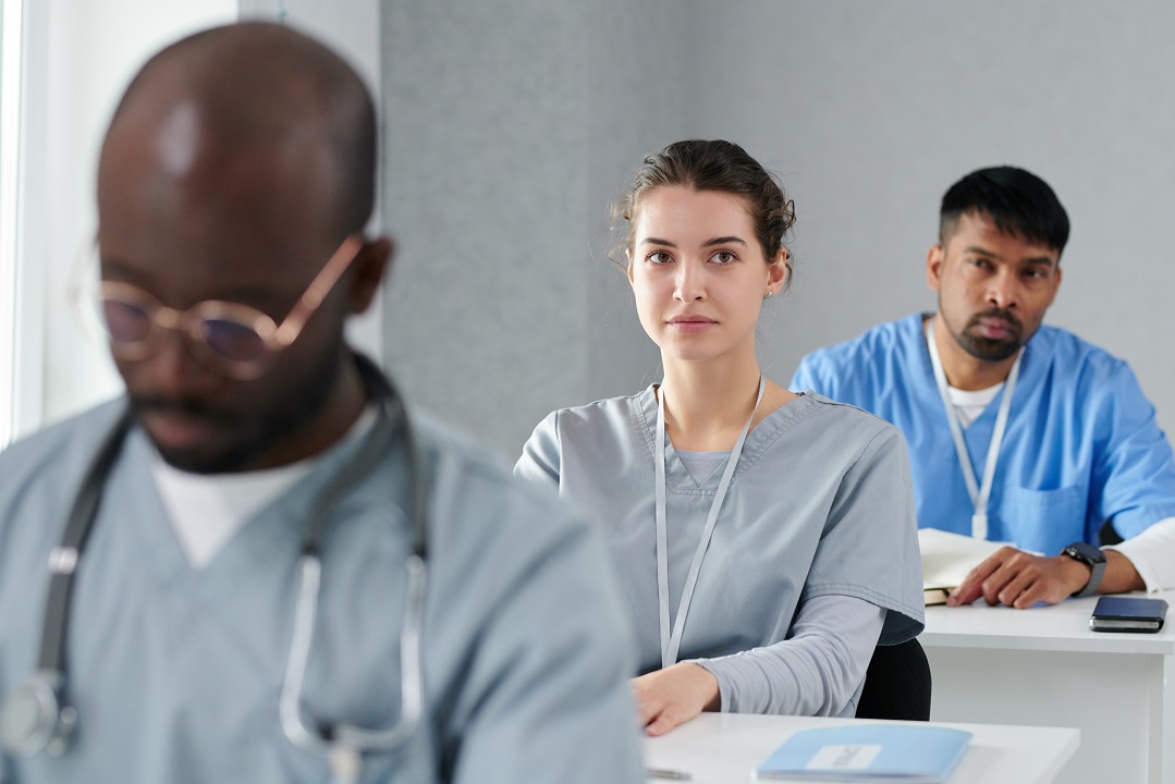 Woman sitting at medical training Healthcare receptionists receiving training to improve front desk performance