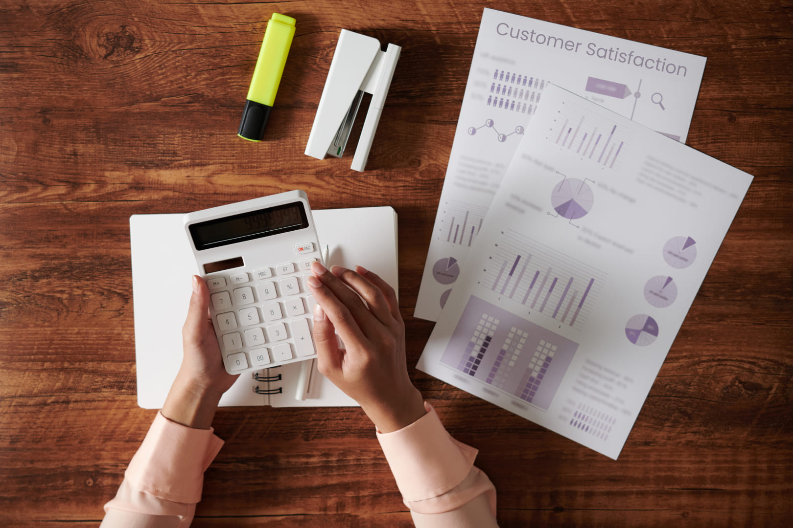 business-manager-learning-how-to-measure-customer-satisfaction-of-business-with-papers-pens-and-calculator-on-wooden-table Business manager learning how to measure customer satisfaction of business with papers, pens, and calculator on wooden table