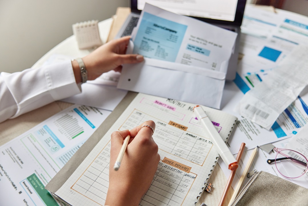 Clinical manager of a physical therapy clinic learning how to improve patient collections with multiple documents on the table